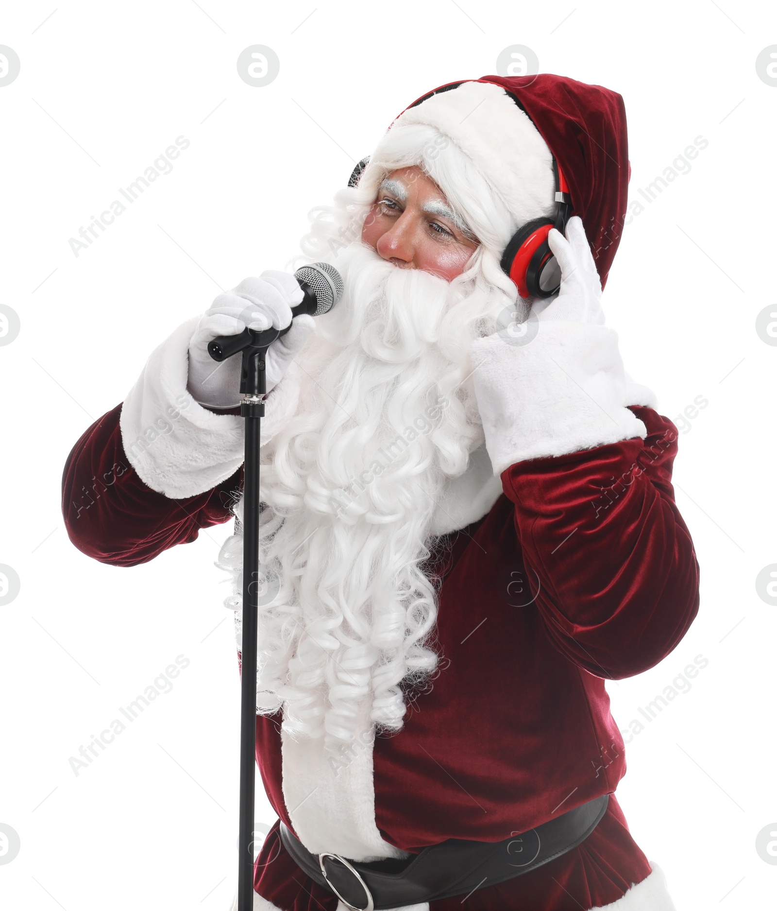 Photo of Santa Claus with headphones and microphone on white background. Christmas music