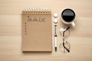 Flat lay composition with unfilled To Do list, cup of coffee and glasses on wooden table