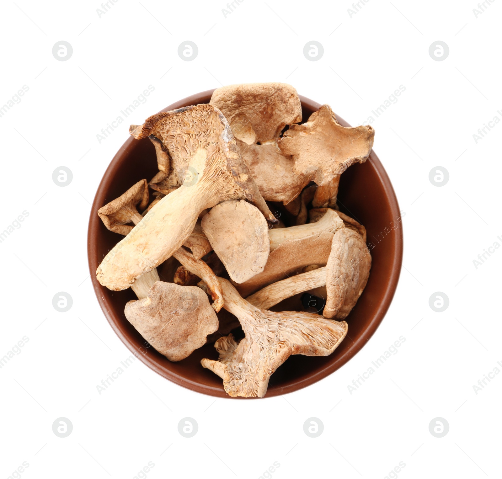Photo of Bowl of dried mushrooms isolated on white, top view