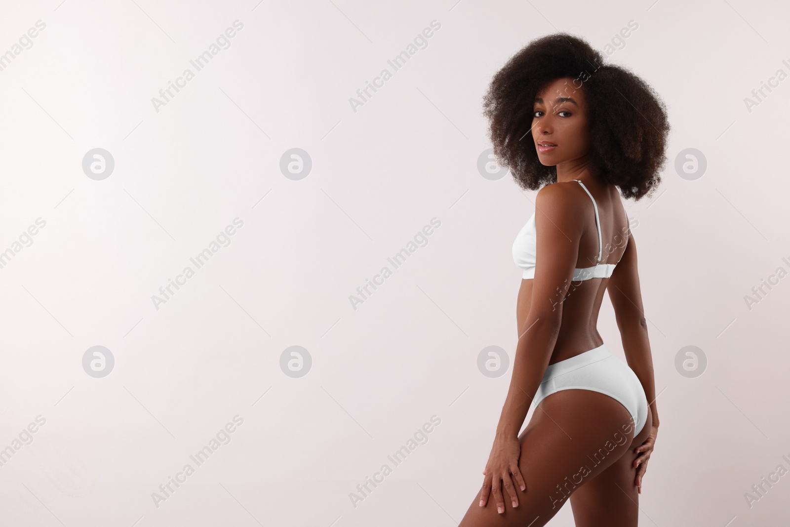 Photo of Beautiful woman in stylish bikini on white background, space for text