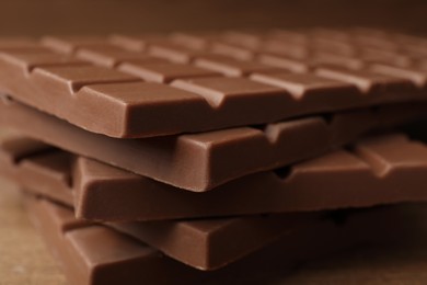 Tasty chocolate bars on wooden table, closeup