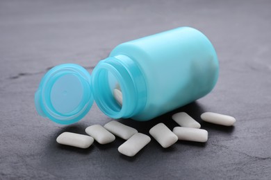 Photo of Jar with chewing gums on grey table