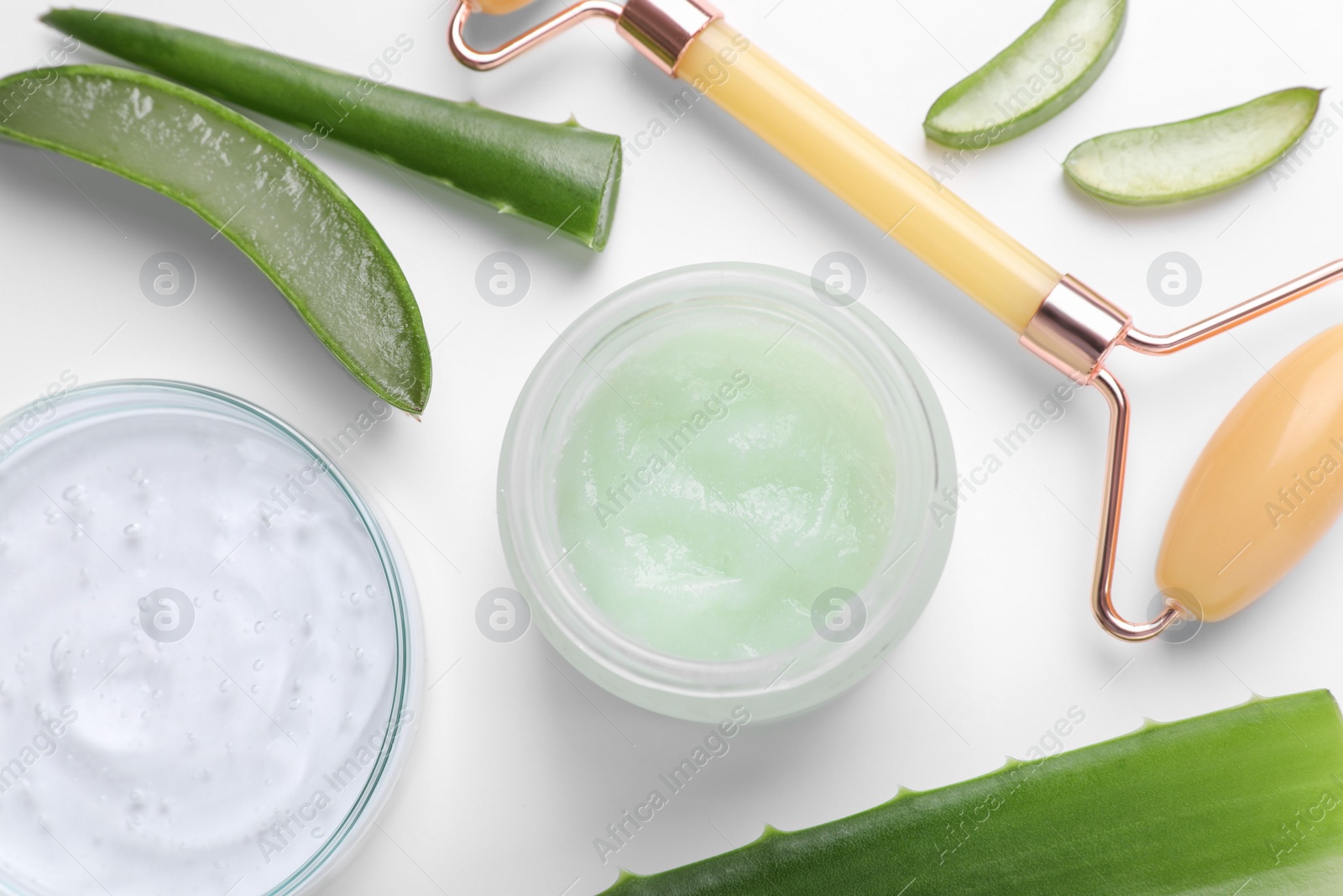 Photo of Flat lay composition with cosmetic products and cut aloe leaves on white background