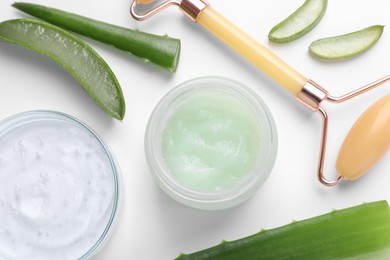 Flat lay composition with cosmetic products and cut aloe leaves on white background