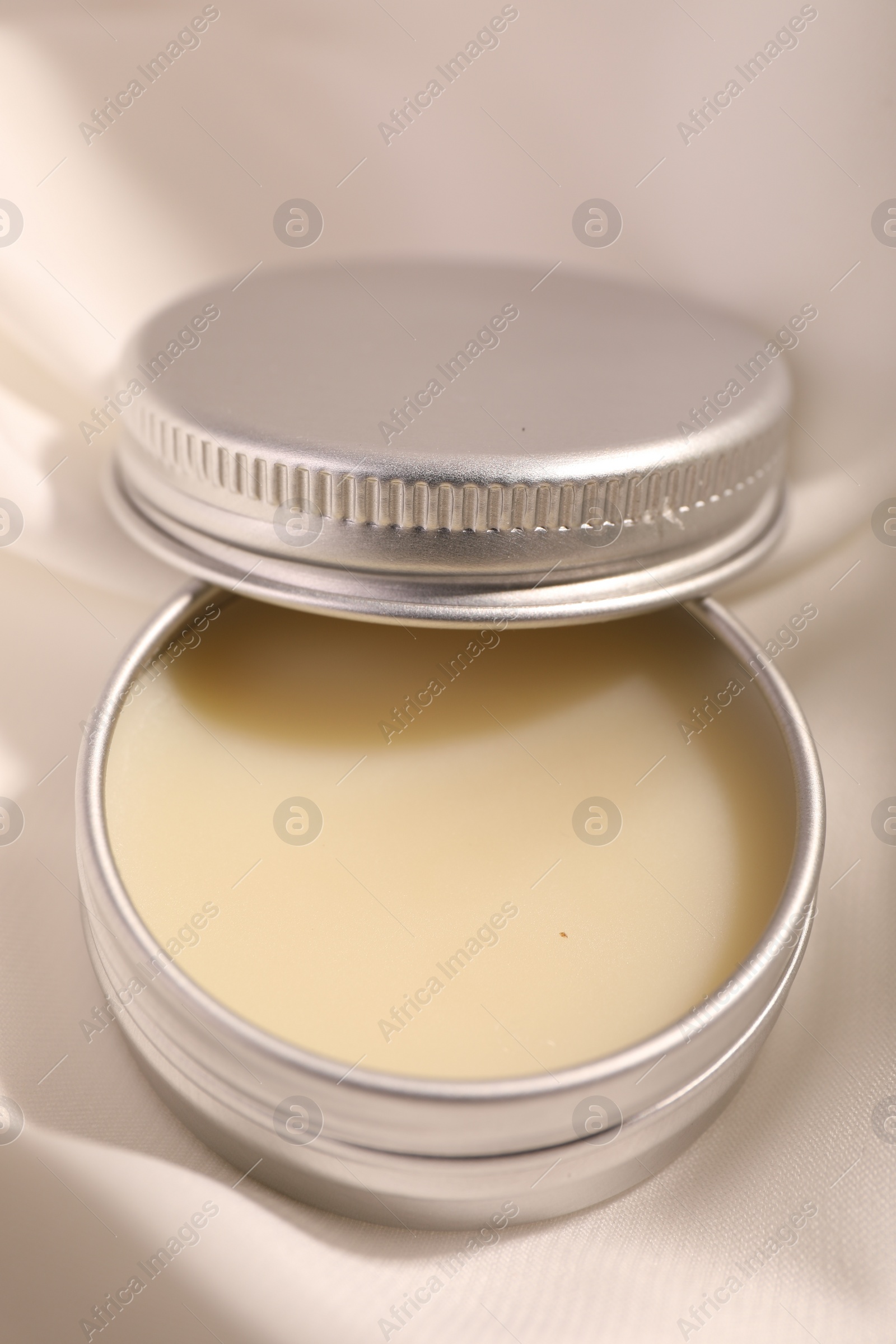 Photo of Lip balm on white fabric, closeup view