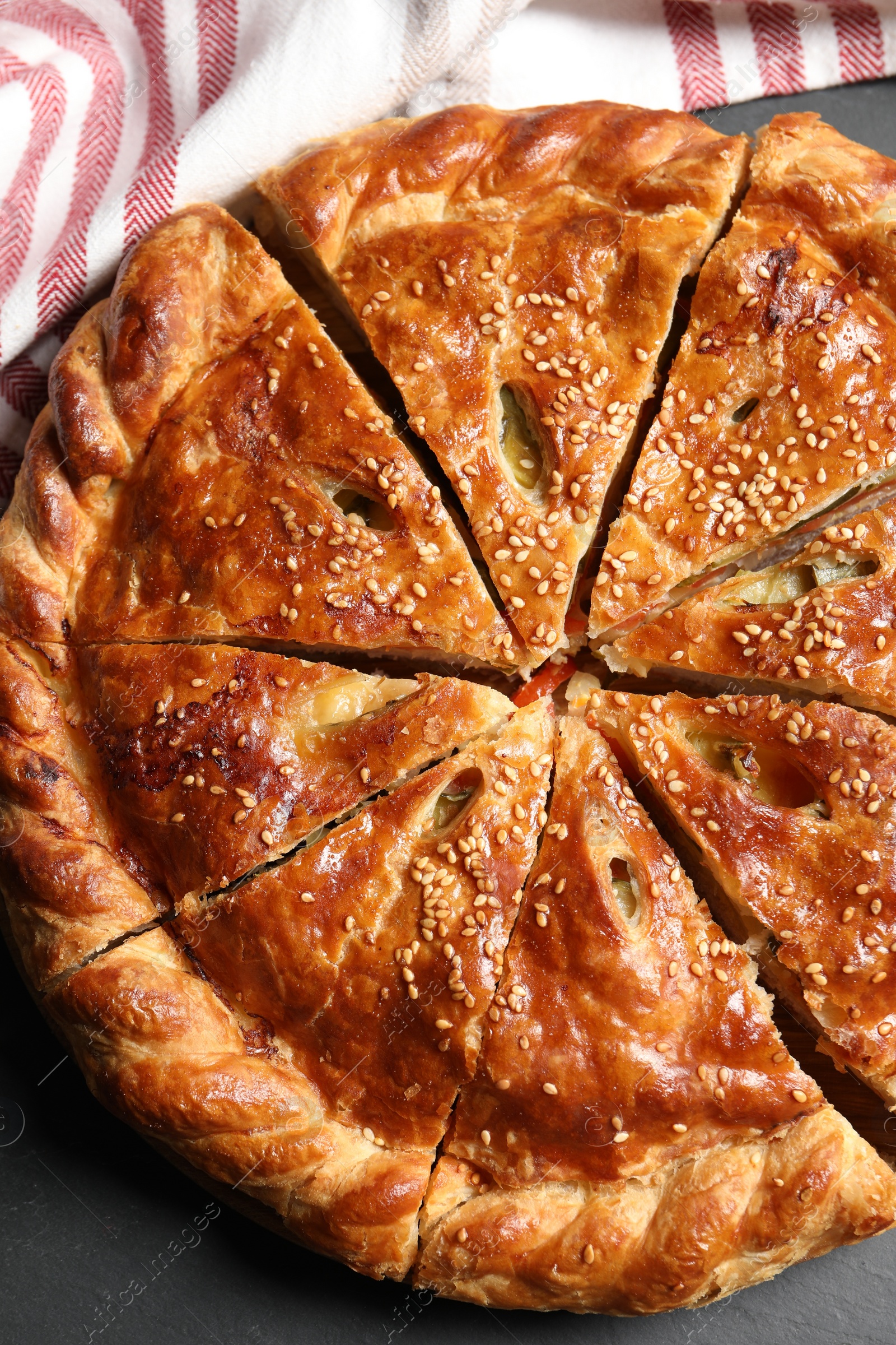 Photo of Cut delicious homemade pie on black table, top view