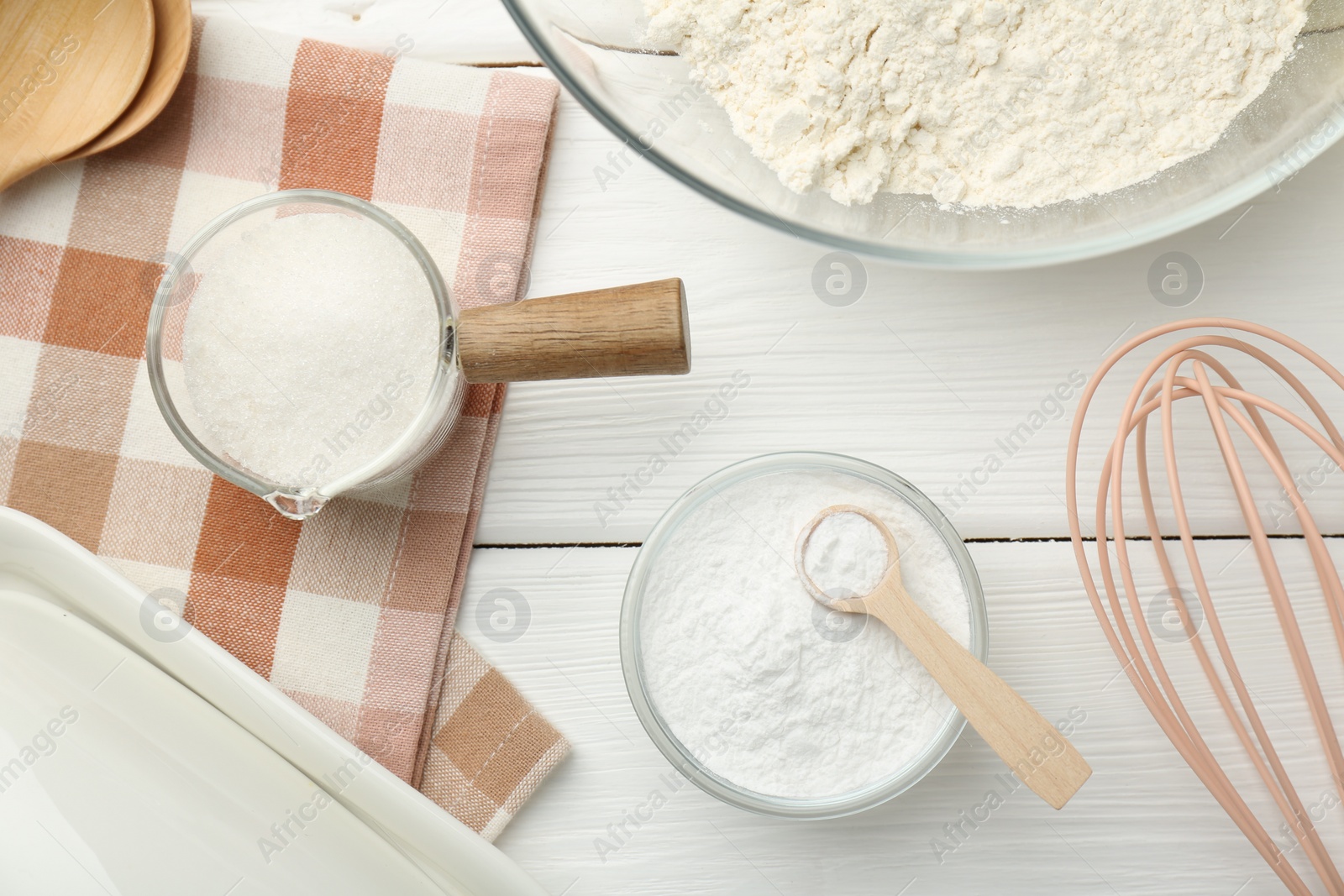 Photo of Flat lay composition with baking powder on white wooden table