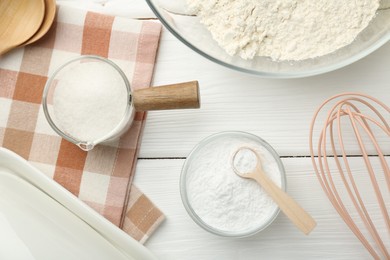 Flat lay composition with baking powder on white wooden table