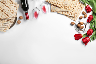 Photo of Flat lay composition with matzos on white background, space for text. Passover (Pesach) celebration