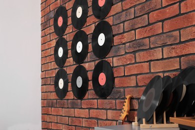 Photo of Vinyl records on brick wall in living room