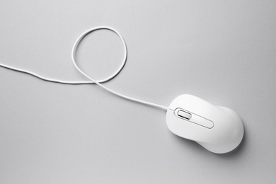 One wired mouse on grey background, top view