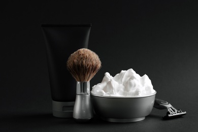 Photo of Set of shaving equipment and men's cosmetic products on black background