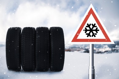 Set winter tires on snow and road sign outdoors