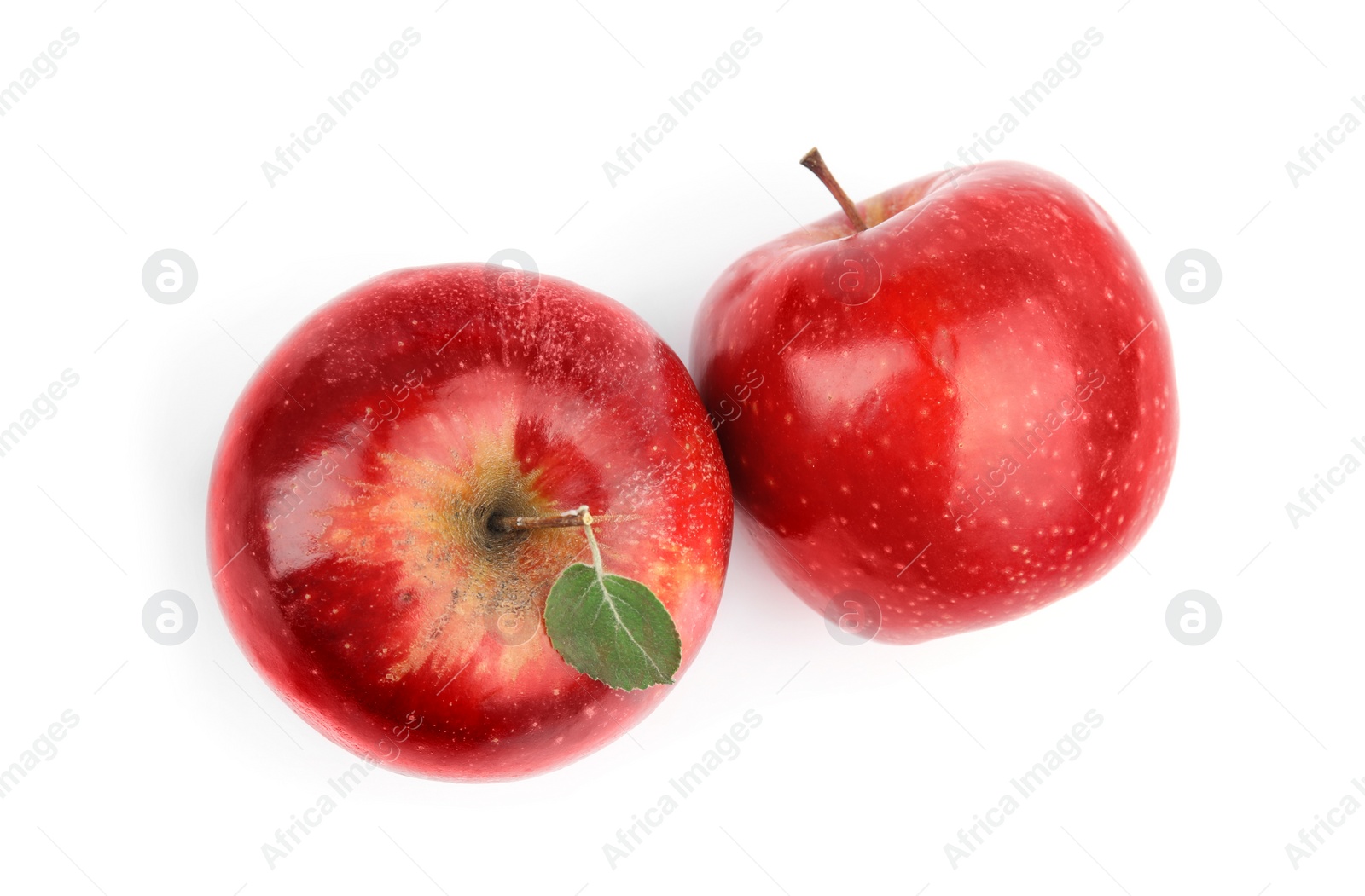 Photo of Ripe juicy red apples with leaf on white background, top view