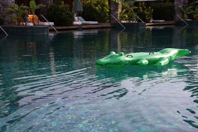 Photo of Float in shape of crocodile in swimming pool at luxury resort