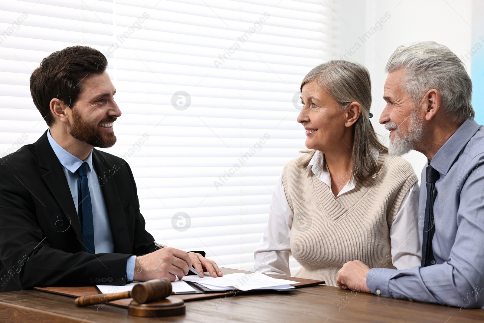Photo of Senior couple having meeting with lawyer in office