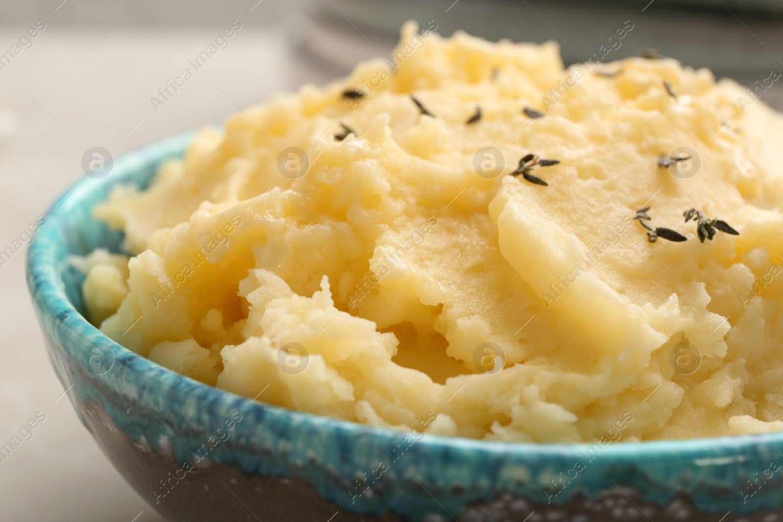 Photo of Bowl with tasty mashed potato on table, closeup