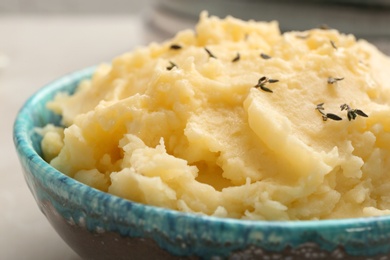 Photo of Bowl with tasty mashed potato on table, closeup