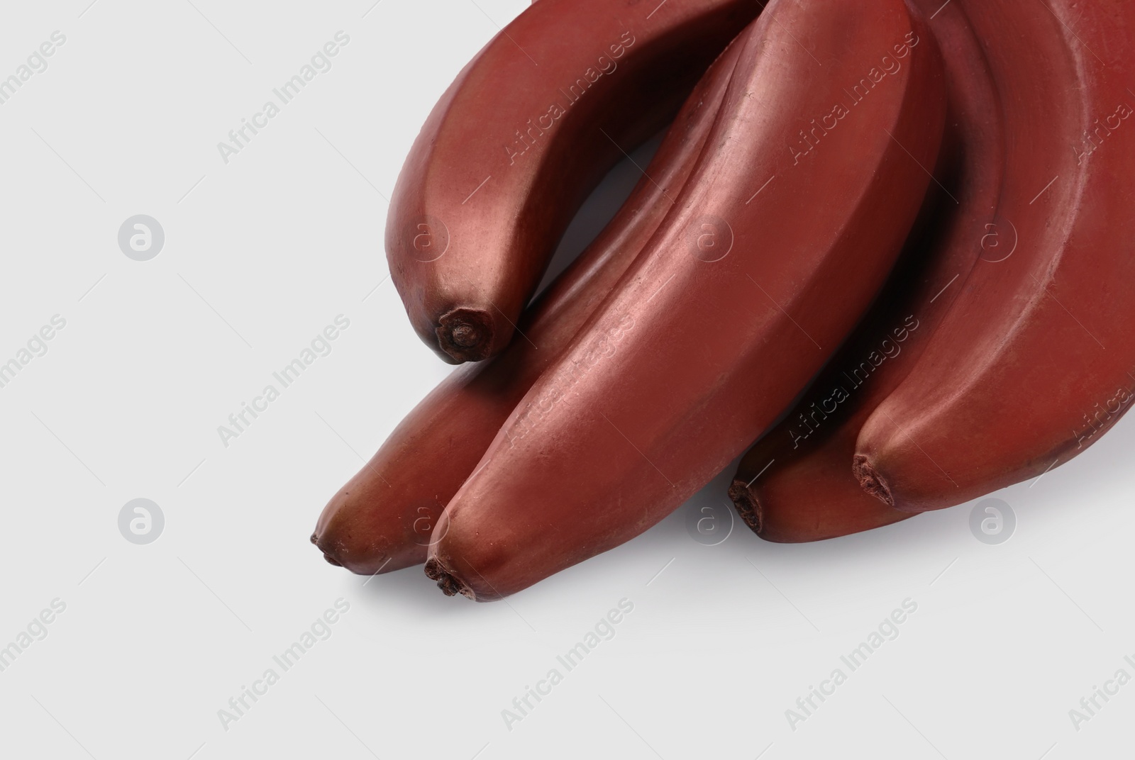 Photo of Tasty red baby bananas on white background, above view