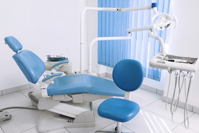Photo of Dentist's office interior with chair and modern equipment