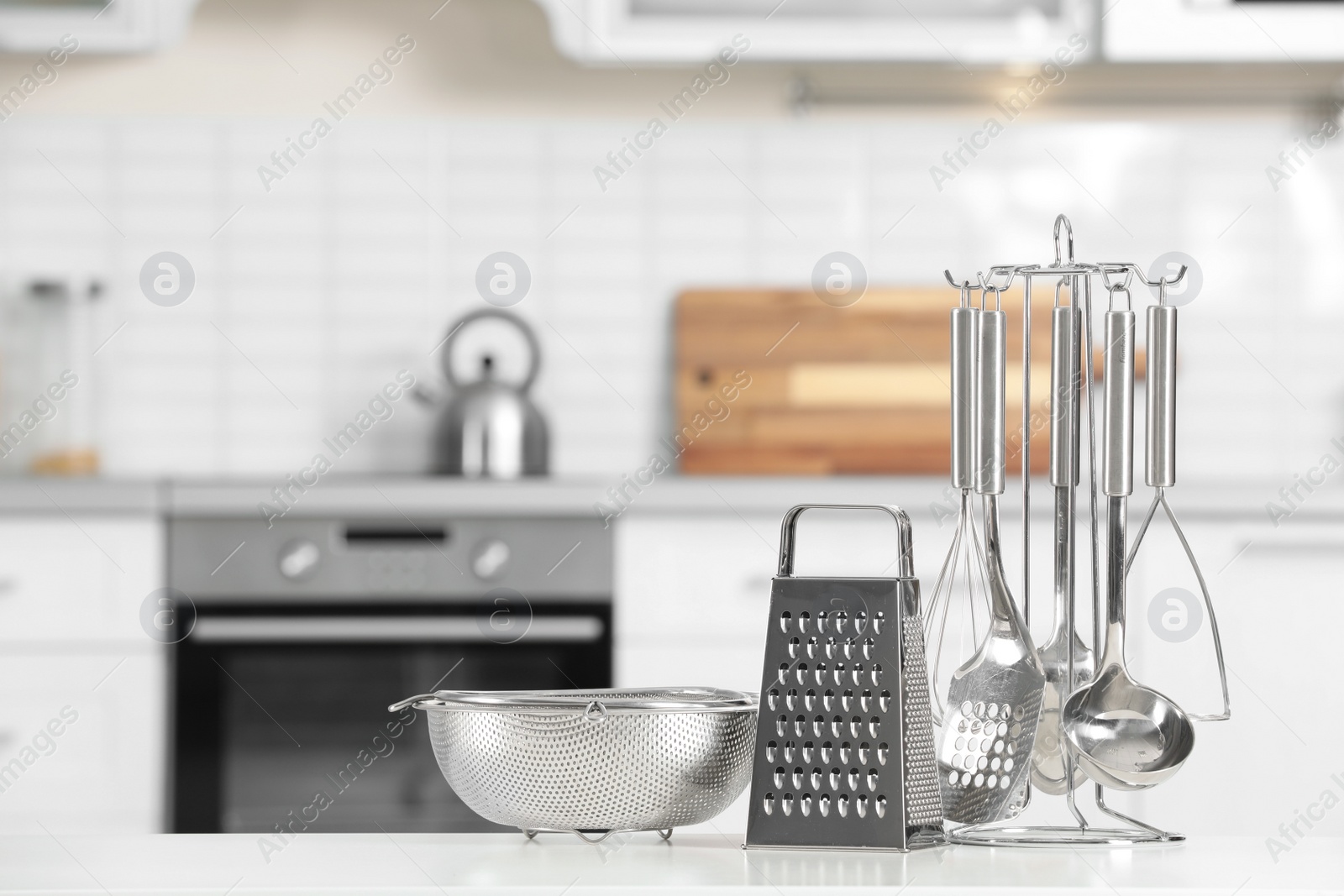 Photo of Set of clean utensils on table in kitchen. Space for text
