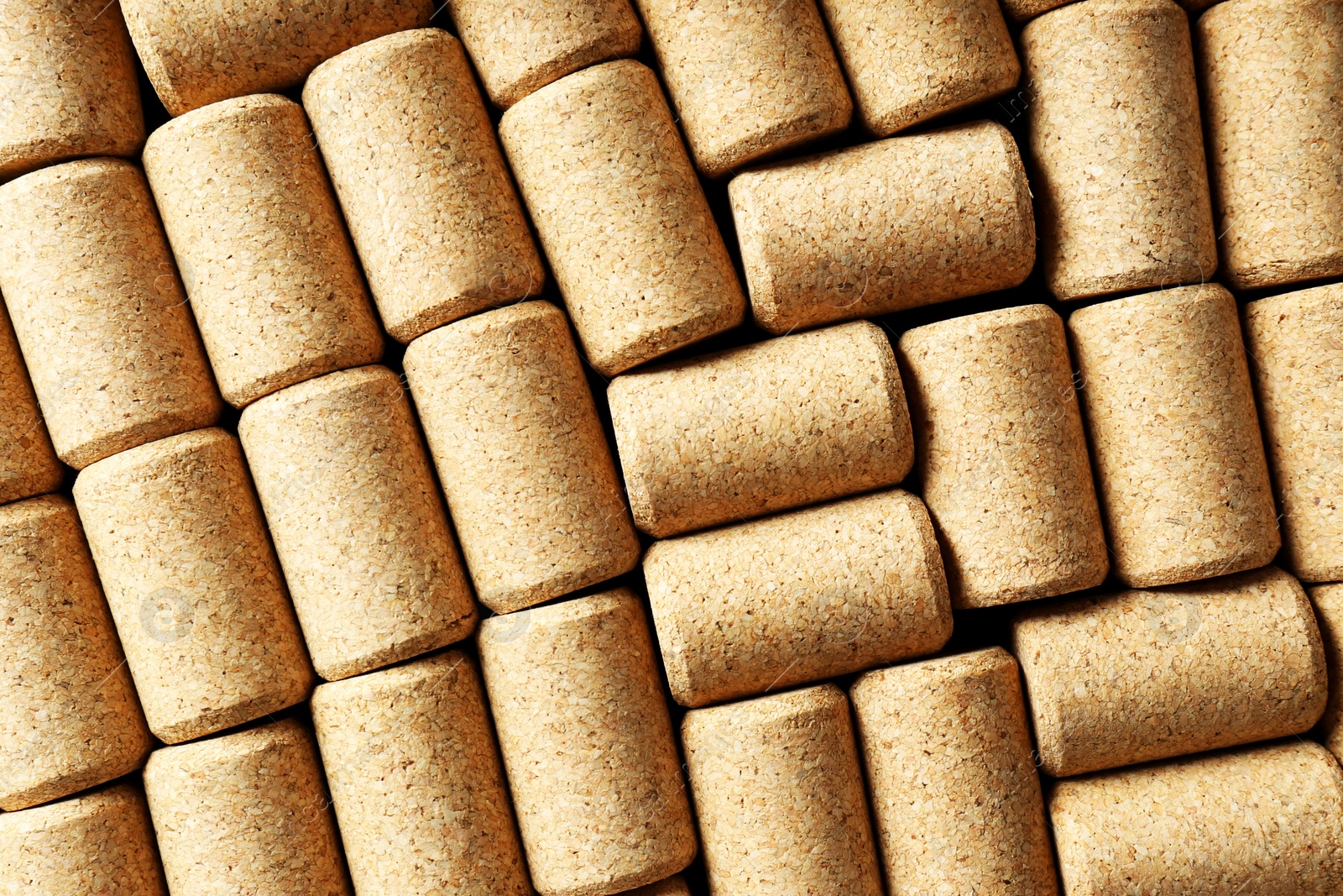 Photo of Many corks of wine bottles as background, top view