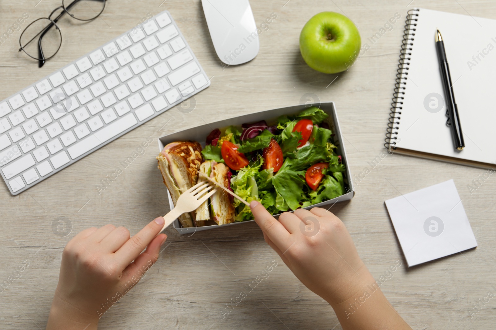 Photo of Office employee having business lunch at workplace, top view