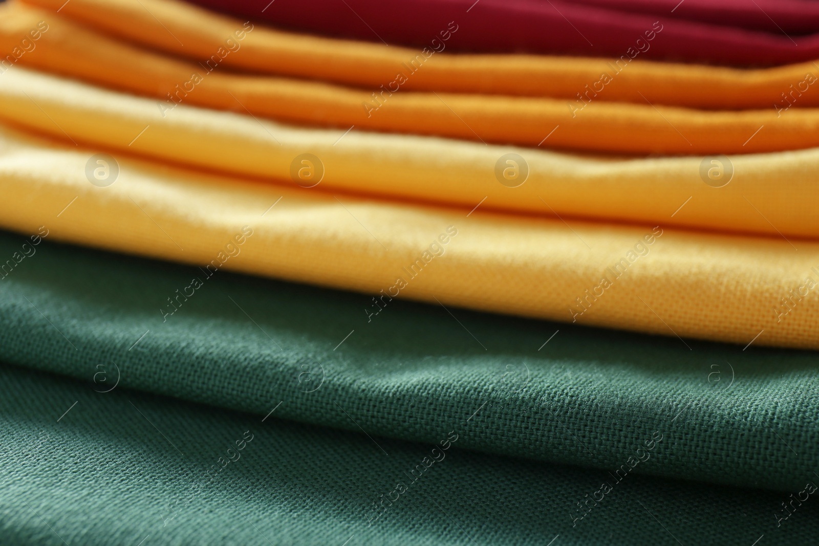 Photo of Different colorful kitchen napkins as background, closeup