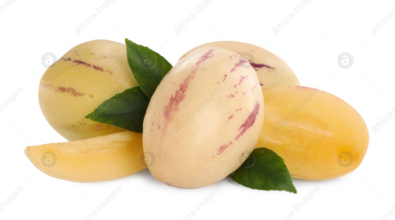 Photo of Whole and cut pepino melons with green leaves isolated on white