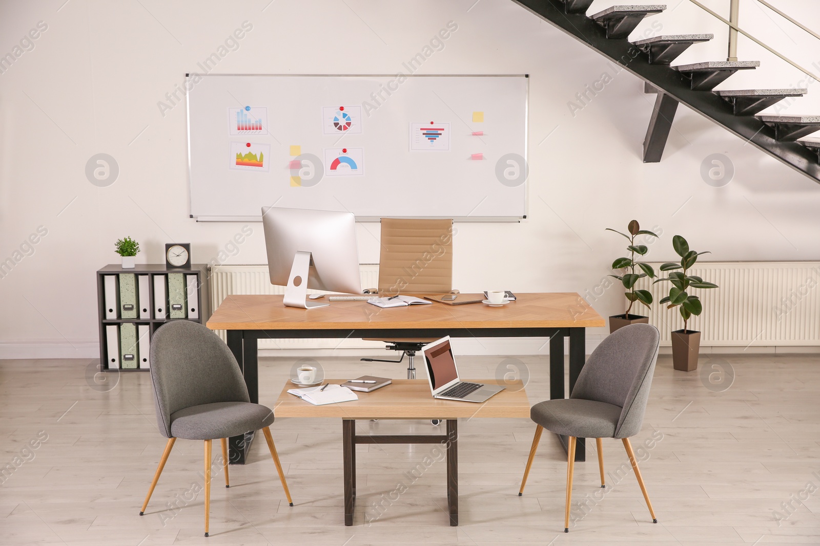 Photo of Stylish office interior with large wooden table