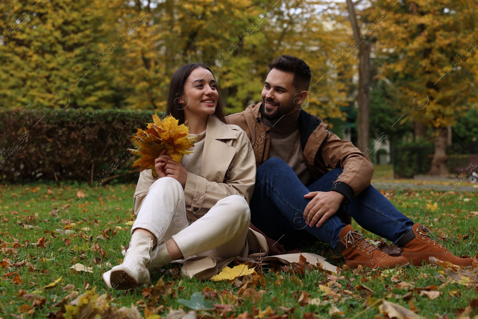 Photo of Happy young couple spending time together in autumn park