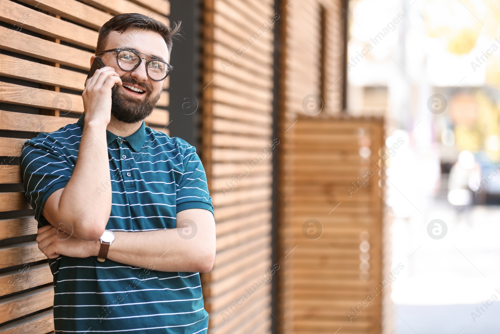 Photo of Portrait of young man talking on phone outdoors