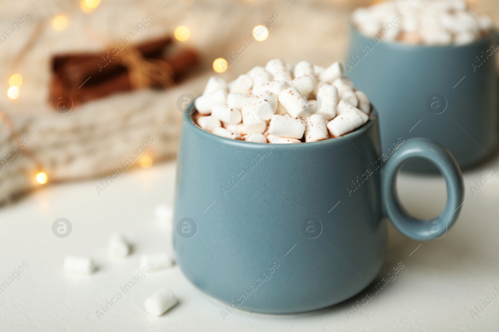 Photo of Delicious cocoa drink with marshmallows on white table