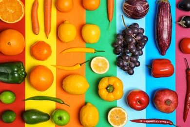 Photo of Rainbow composition with fresh vegetables and fruits on color background, flat lay