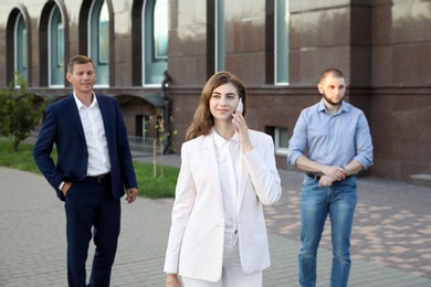 Different people walking on modern city street