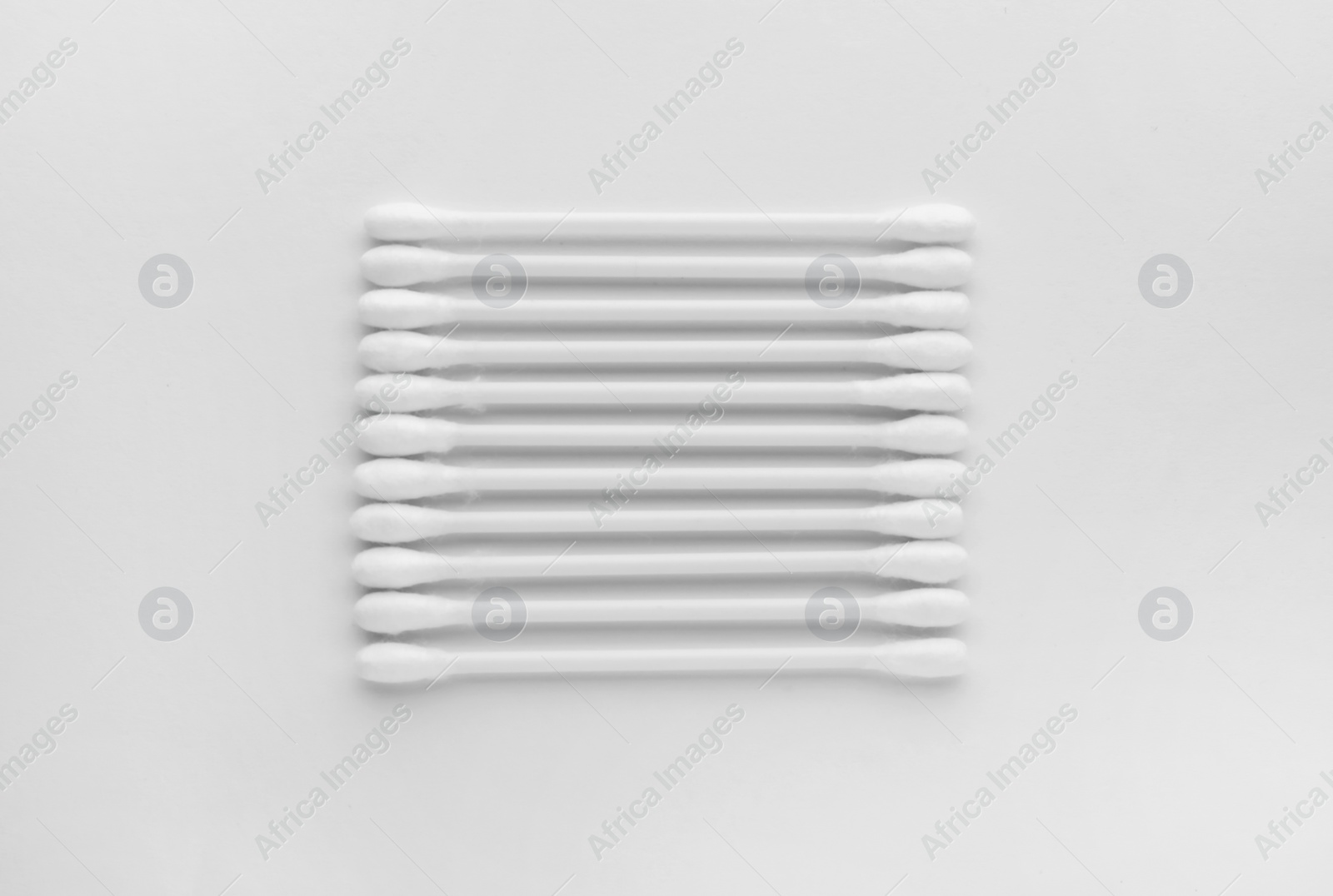 Photo of Clean cotton buds isolated on white, top view