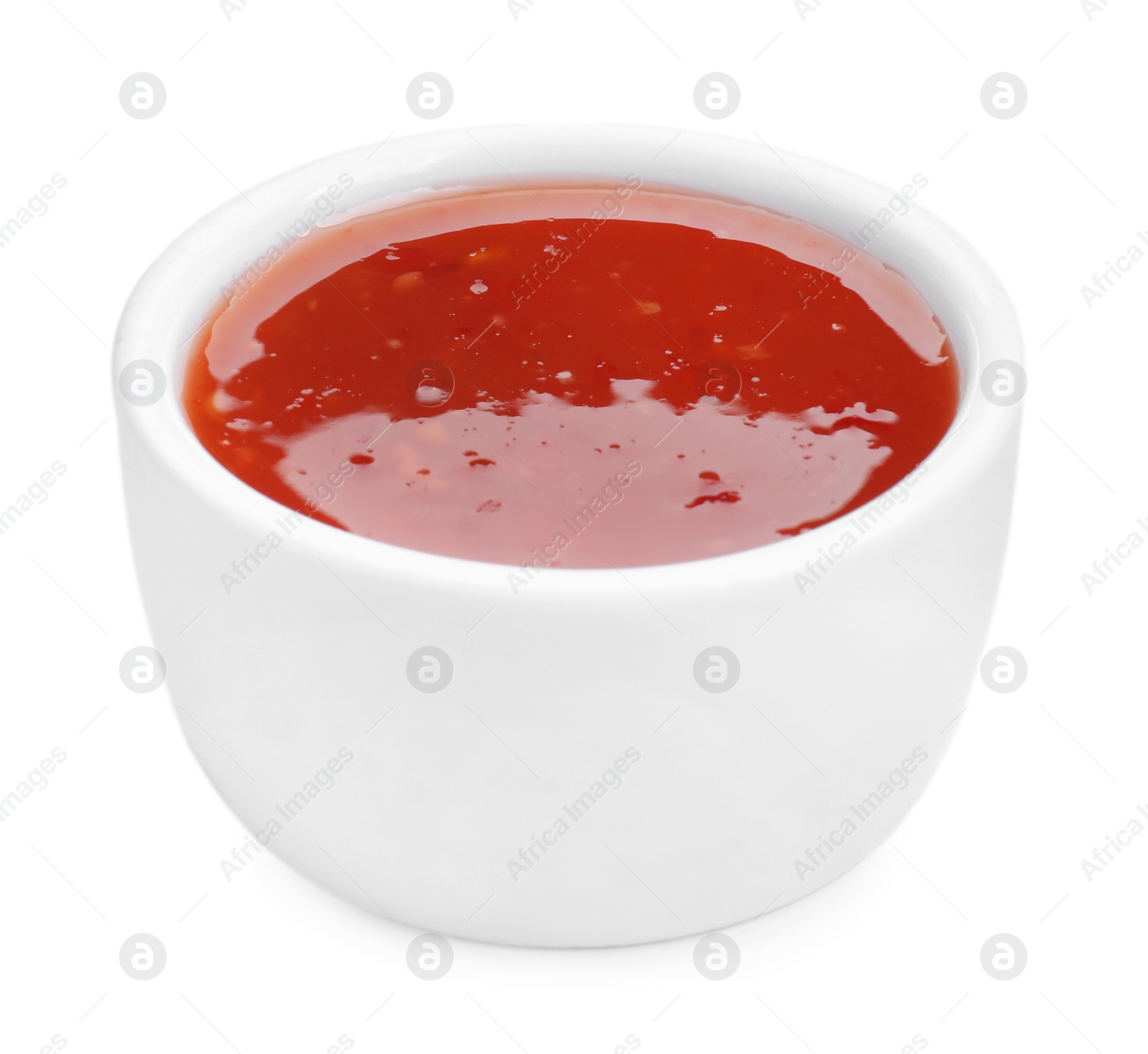 Photo of Spicy chili sauce in bowl isolated on white