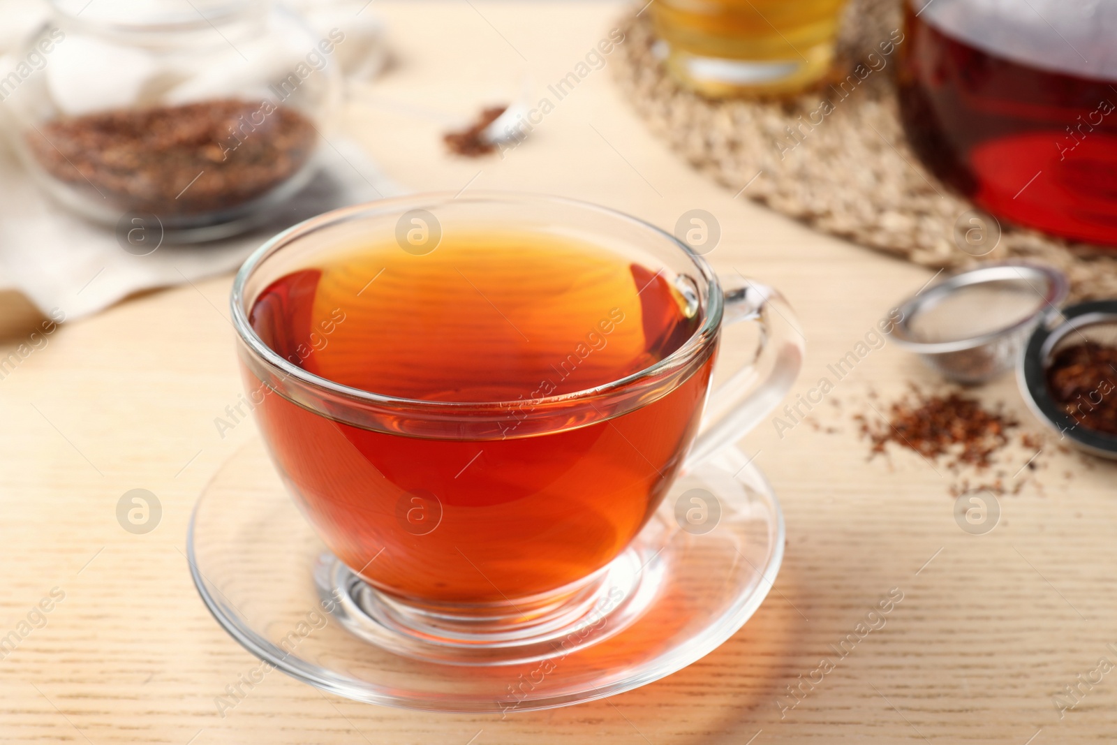 Photo of Freshly brewed rooibos tea on wooden table