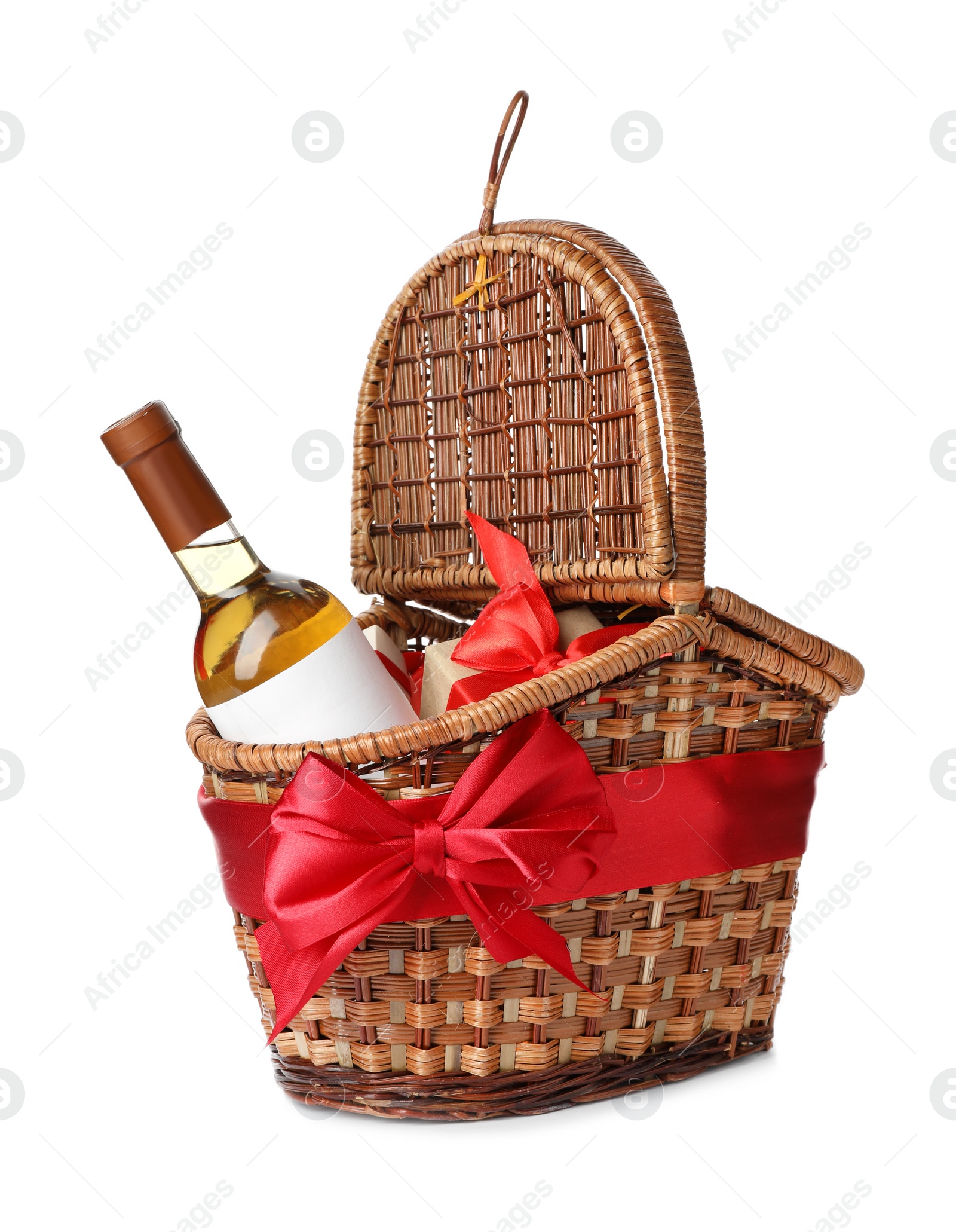 Photo of Festive basket with bottle of wine and gift on white background