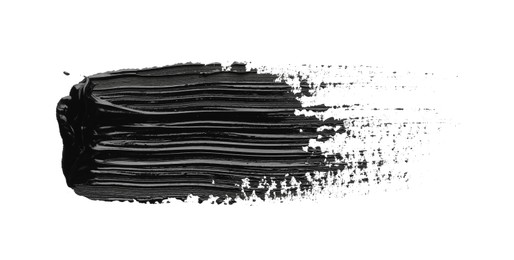 Photo of Brushstroke of black oil paint on white background, top view