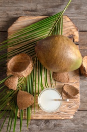 Photo of Composition with fresh green coconut and jar of milk on wooden table