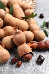 Delicious ripe tamarinds on grey table, closeup