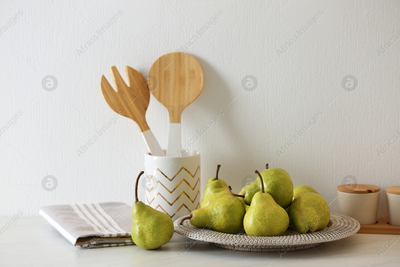 Photo of Plate with fresh ripe pears on white table