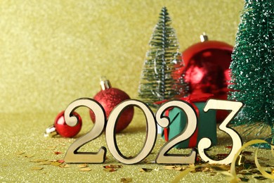 Photo of Number 2023 and festive decor on bright background. Happy New Year