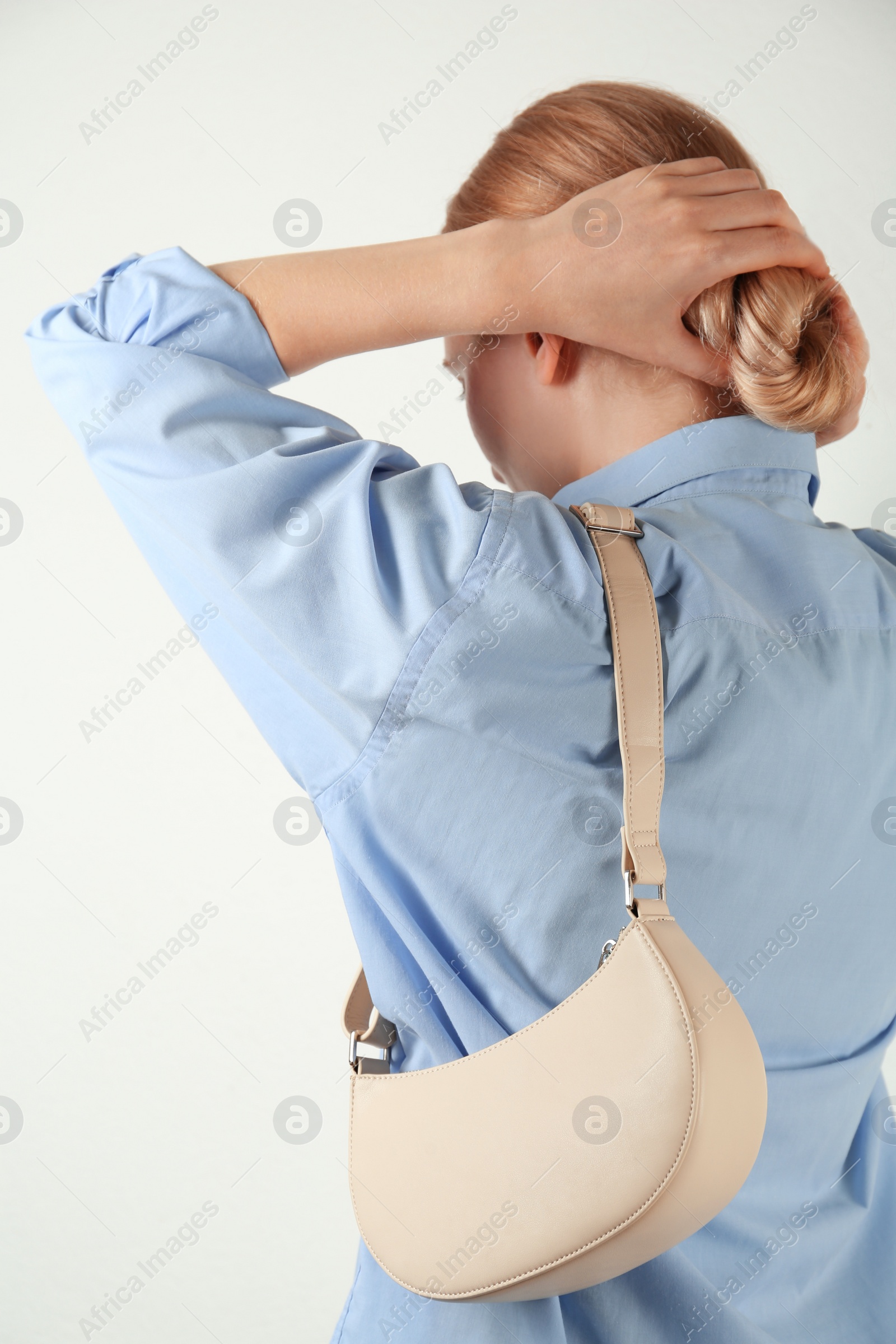 Photo of Woman with stylish baguette handbag on white background