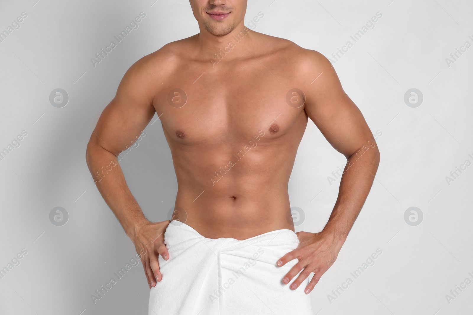 Photo of Man with sexy body on light background, closeup