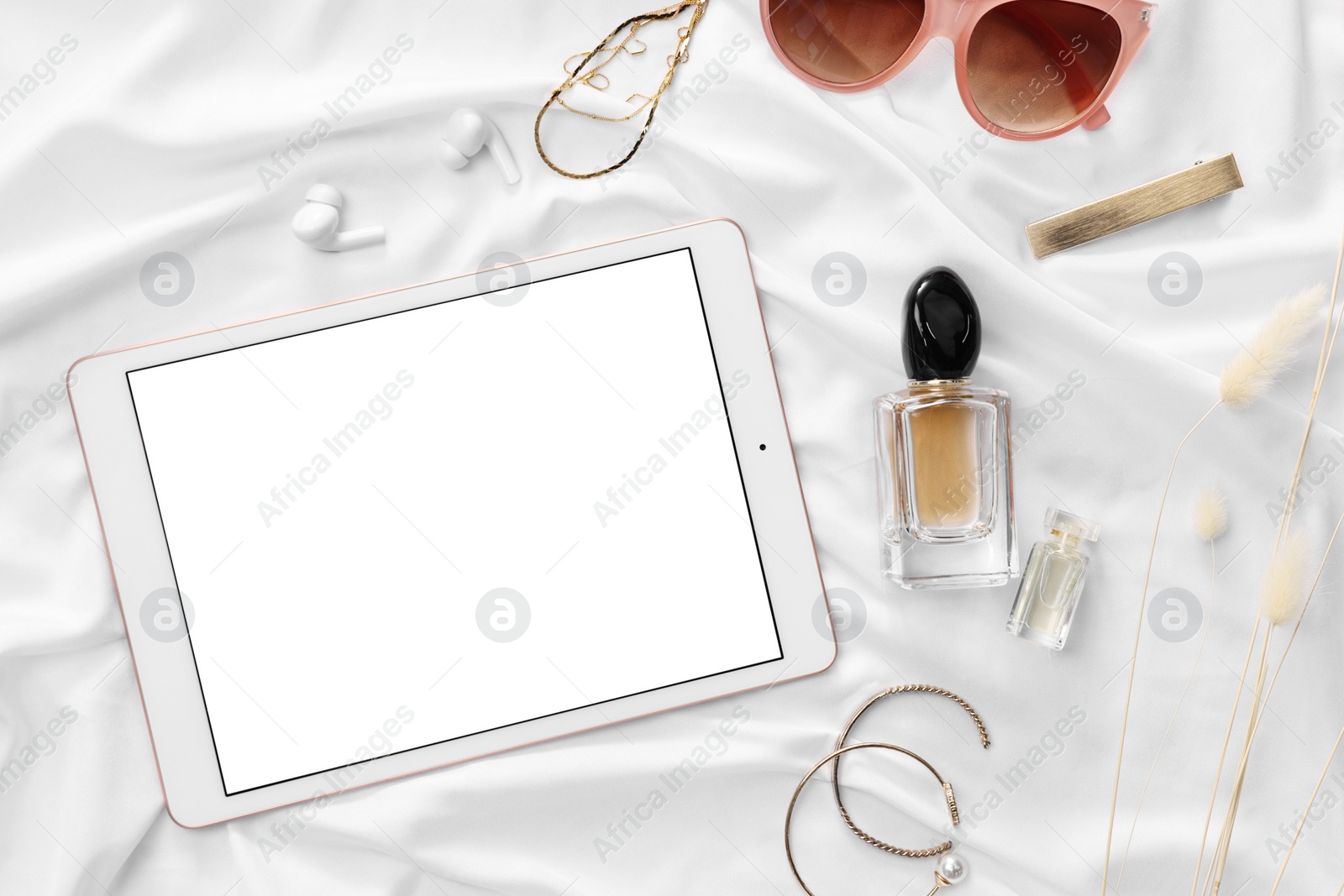 Photo of Flat lay composition with modern tablet on white fabric. Space for text