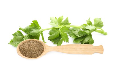 Photo of Spoon of celery seeds and fresh plant isolated on white, top view