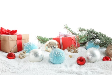 Fir branches, Christmas decoration and snow against white background