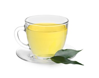 Photo of Fresh green tea in glass cup, leaves and saucer isolated on white